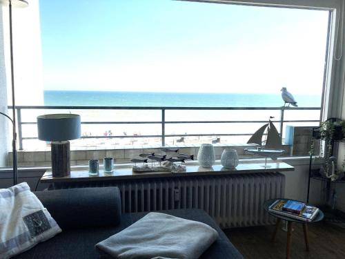 a living room with a view of the ocean at Strandhotel-Superblick-60 in Dahme