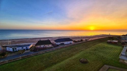 an aerial view of a beach at sunset at Strandhotel-Superblick-60 in Dahme
