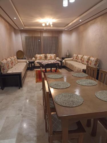 a large living room with tables and couches at Nouaceur Garden Comfort and Serenity Casa Airport in Nouaseur