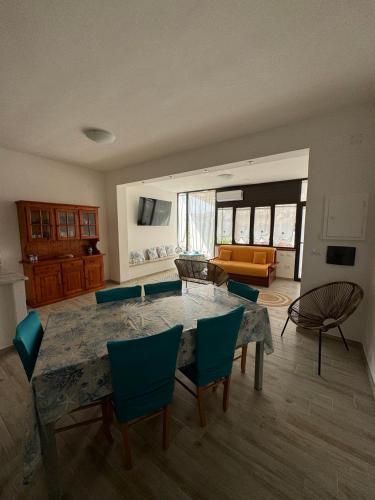 a living room with a large table and chairs at Endless Summer House in I Casoni