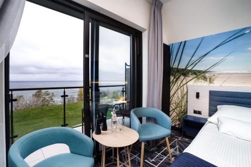 Postel nebo postele na pokoji v ubytování Hotel Faleza - z widokiem na morze