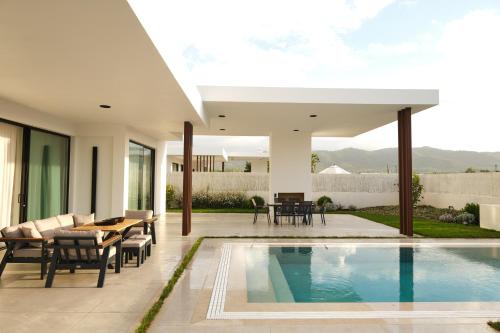 a villa with a swimming pool and a patio at Ashta Gold Suite in Fethiye