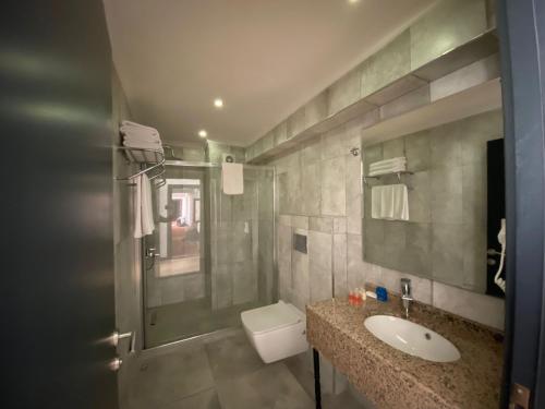 a bathroom with a sink and a toilet and a shower at Carpediem Diamond Hotel in Karasu