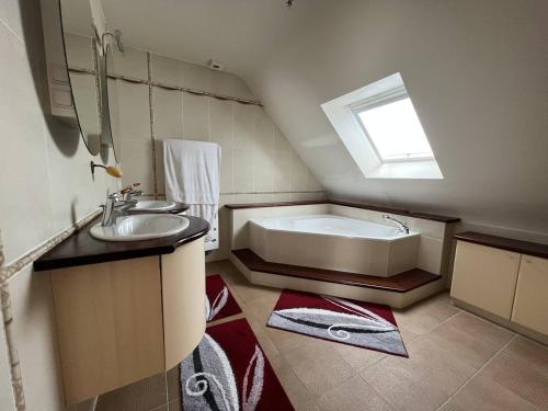 a bathroom with a sink and a bath tub at Maison 6 personnes Saint Cast Le Guildo in La Garde