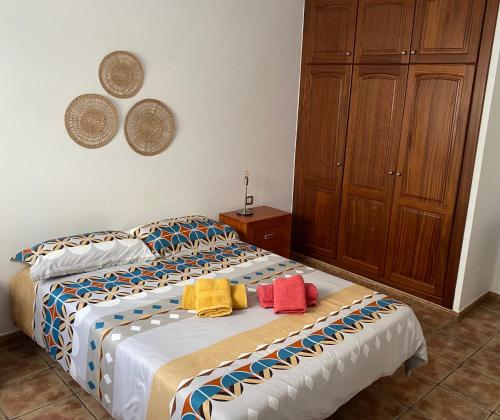 a bedroom with two beds with towels on them at Casa Rosa in Famara