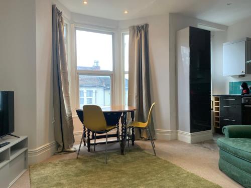 a dining room table and chairs in a living room at Central 2 bed flat. Free parking (Off-street) in Bristol