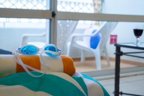 a woman with goggles on her face laying on a bed at Leonardo Club Eilat - All Inclusive in Eilat