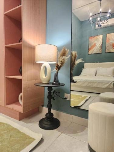 a room with a bed and a table with a lamp at Afidea Homestay Kids Friendly Condo In Nilai-Netflix,Game in Nilai