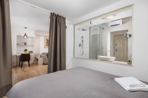a bedroom with a bed and a bathroom with a sink at Apartment Wow in Rijeka