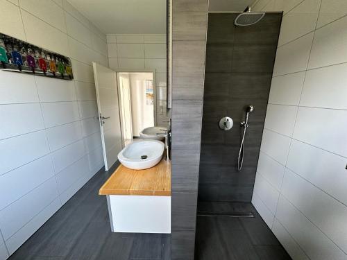 a bathroom with a shower and a toilet in it at Haus am See in Barßel