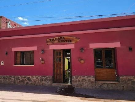 a red building with a sign that reads titan motel at Tilcara Hostel in Tilcara