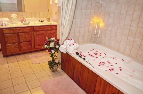 a bathroom with a bath tub filled with roses at Bavarian Inn Motel & Restaurant in Eureka Springs