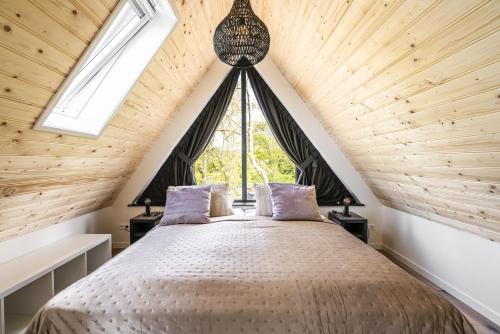 a bedroom with a bed with a large window at Nieuw vakantiehuis Domburg, in centrum dichtbij strand in Domburg