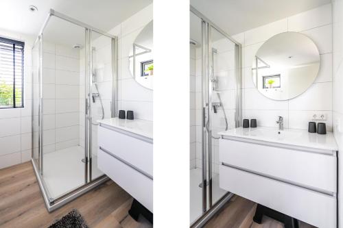 a bathroom with two sinks and a shower at Nieuw vakantiehuis Domburg, in centrum dichtbij strand in Domburg