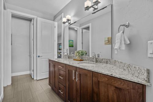 a bathroom with a sink and a large mirror at Entrada at Moab 420 and 424 in Moab