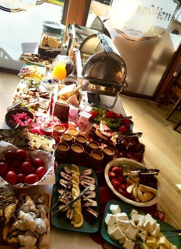 a table with many different types of food on it at Blumenhof Bucovina in Voronet
