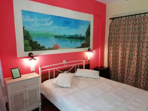 a bedroom with a large painting above a bed at Meteora Garden in Kalabaka