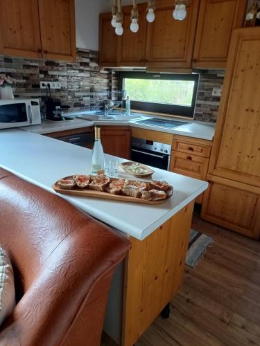 a kitchen with a counter with a plate of food on it at Csencsó Vendégház in Ciumani