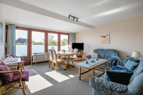 a living room with a couch and a table at Hoern 2 in Nordstrand