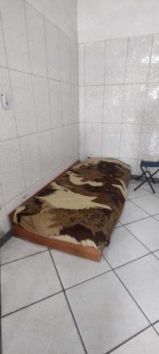 a bed in a corner of a room at Argentina House in Sao Paulo