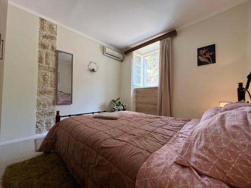 a bedroom with a bed and a window at Nonas House in Kanoni