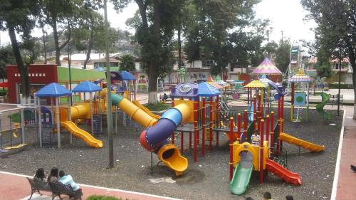a playground with a bunch of slides and slidesktop at Hotel Villa Monarca Inn in Zitácuaro