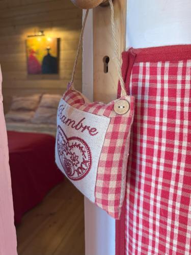 a red and white towel hanging on a wall at Chalet des Myrtilles - chalet cosy avec vue in Arette