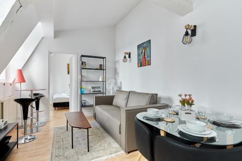 un salon avec un canapé et une table dans l'établissement Charming 1 bedroom flat Coeur du Marais By Studio Prestige, à Paris