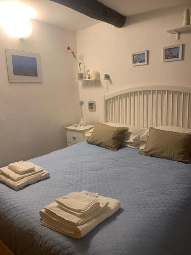 a bedroom with a bed with two towels on it at CASABARBARA lerici in Lerici