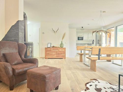 a living room with a couch a chair and a table at Black Forest I Sauna auf dem Balkon I Boxspring I Nespresso I Ausblick I Wasserfälle im Ort in Todtnau