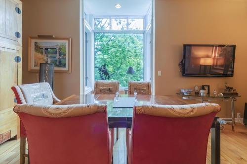 a dining room with a table and red chairs at Tree House - Downtown Saugatuck - Walk to all the local shops in Saugatuck