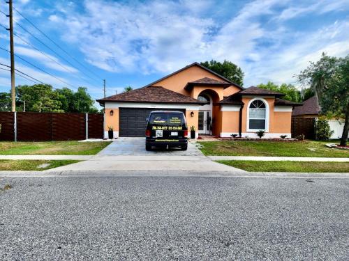a black van parked in front of a house at Happy Place in Orlando