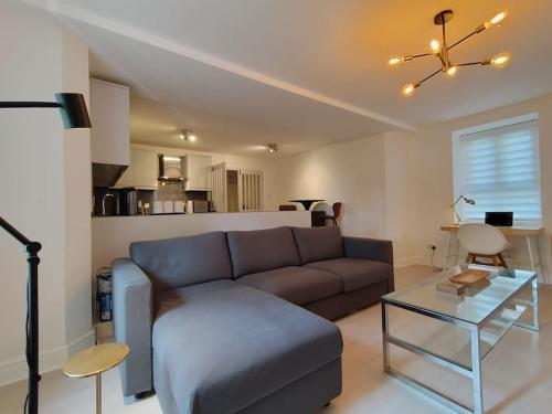 Bijou White Hart Lane في لندن: غرفة معيشة مع أريكة وطاولة