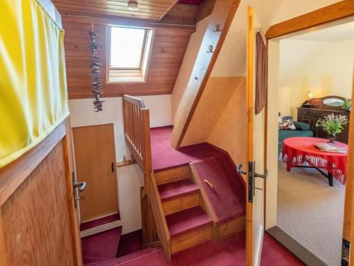 a staircase in a tiny house with a red carpet at Gartentraum, Feuergrill, Kids-Spielwelt, 4Räume in Hartenstein