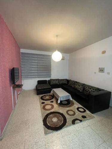 a living room with a couch and a table at Buse's Home in Mağusa