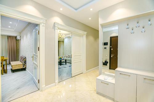 uma casa de banho com uma cabina de duche ao nível do chão e uma sala de jantar em Park Azure Luxury apartment by Baku Housing em Baku