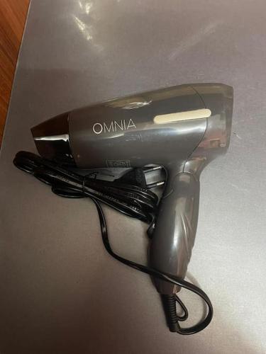 a hair dryer sitting on top of a table at Buse's Home in Mağusa