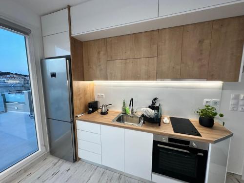 a kitchen with a sink and a refrigerator at Utopia View in Mytilini
