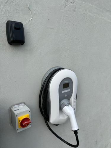 a phone hanging on a wall next to a camera at Idyllic, 5 Star Family Home with Panoramic Views, Kinvara on the Wild Atlantic Way in Kinvara