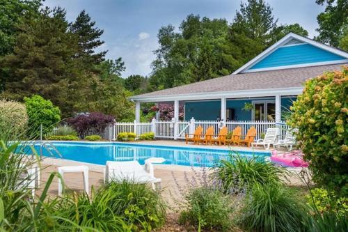 a house with a swimming pool in the yard at Blueberry Beach House indoor pool, hot tub in South Haven