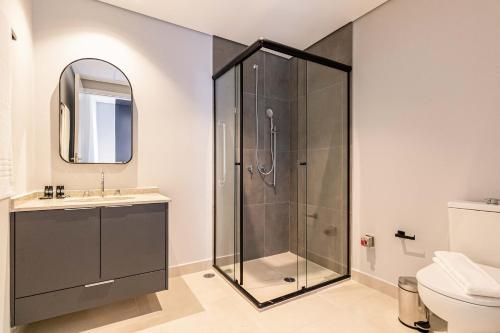 a bathroom with a shower and a sink at Charlie Houx Pinheiros in Sao Paulo