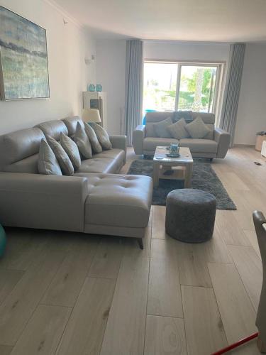 a living room with a couch and a table at Vila Sol, Apartment 468 in Quarteira