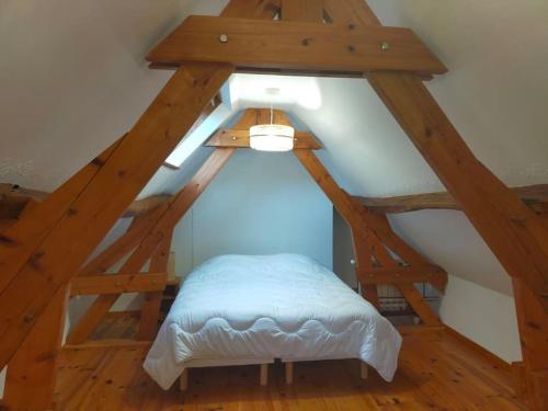 a room with an attic with a bed in it at Longère 10 personnes in Vauchelles-lès-Quesnoy