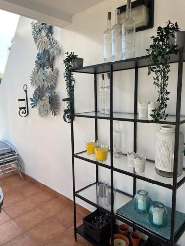 a black shelving unit in a room with drinks on it at Vila Sol, Apartment 468 in Quarteira
