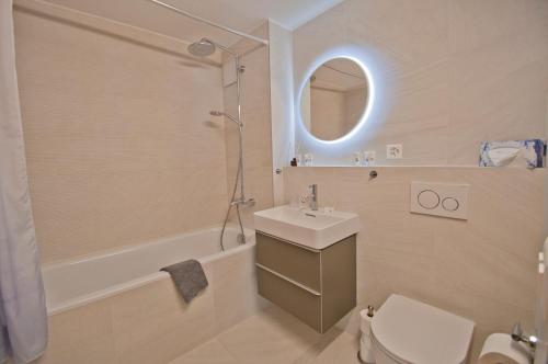 a bathroom with a sink and a shower and a toilet at Haus Bodmen C, Apartment Grünsee in Zermatt