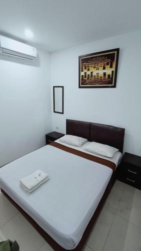 a large bed in a room with at VI Hotel Bandung in Bandung
