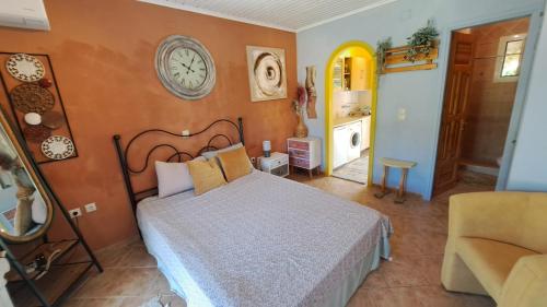 1 dormitorio con 1 cama y reloj en la pared en 3 bedroom house w/private pool, en Astrakeri