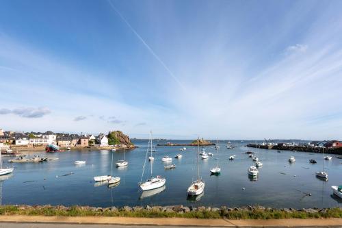 a group of boats are docked in a harbor at Charmante maison de pecheur in Ploubazlanec