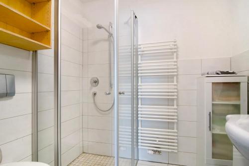 a shower with a glass door in a bathroom at Ferienwohnung Honberg in Tuttlingen