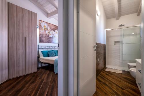 a bathroom with a bed and a toilet in a room at La Chicca in Valledoria